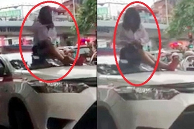 Nữ tài xế taxi leo lên nóc xe “ăn vạ” khi bị cảnh sát giao thông dừng xe