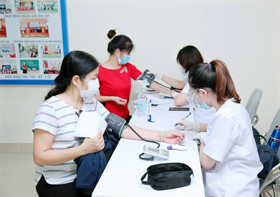 Chùm ảnh: Hơn 2.400 người dân quận Thanh Xuân tiêm vaccine phòng Covid-19 - Ảnh 4