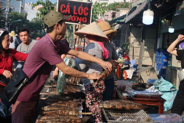 Người dân TP Hồ Chí Minh đổ xô đi mua cá lóc nướng cúng Thần Tài - Ảnh 8