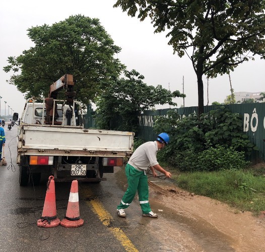 Đội mưa dọn dẹp bùn đất trên Đại lộ Thăng Long - Ảnh 6