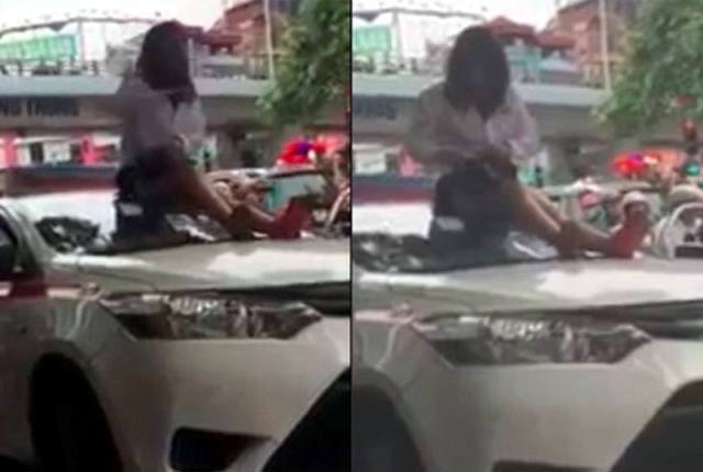 Nữ tài xế taxi leo lên nóc xe “ăn vạ” khi bị cảnh sát giao thông dừng xe - Ảnh 1