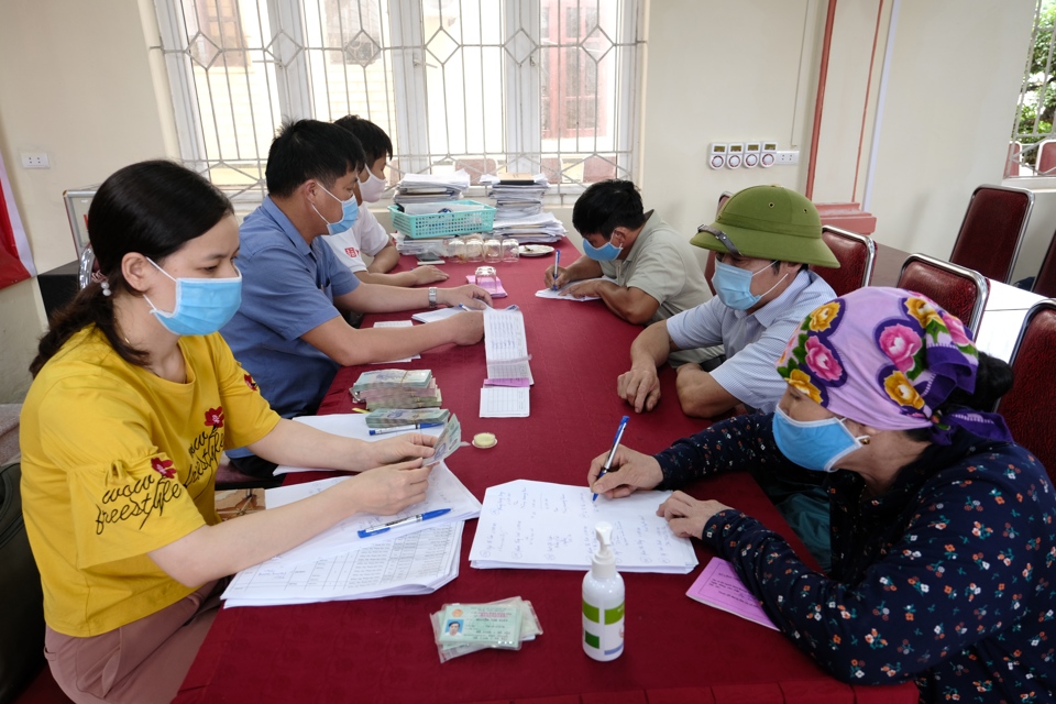 Trao tiền hỗ trợ cho người dân gặp khó khăn tại xã Đại Thịnh, huyện Mê Linh. Ảnh Phạm Hùng (1)