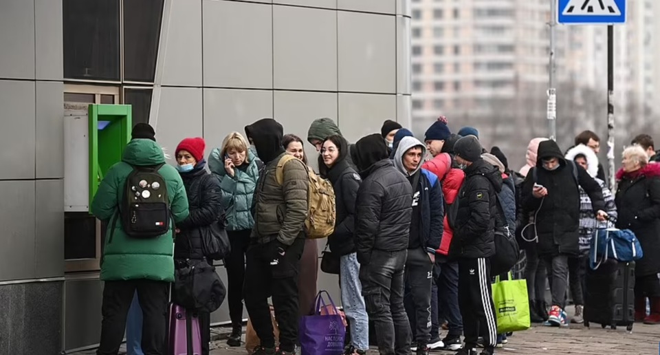 Người d&acirc;n xếp h&agrave;ng r&uacute;t tiền ở một c&acirc;y ATM tại Kiev. Ảnh: AFP