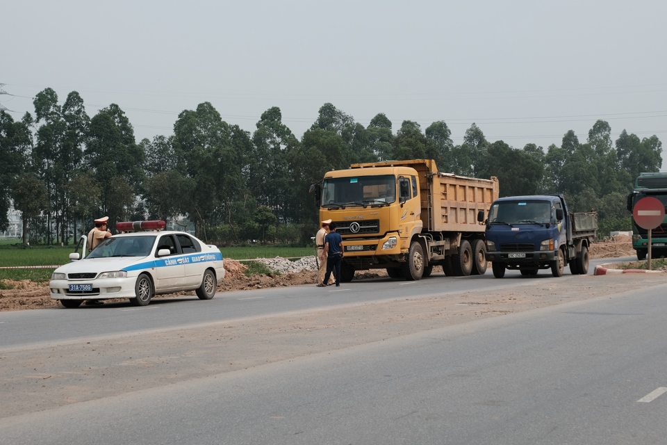 Cảnh sát giao thông kiểm tra, xử lý lái xe tải vi phạm trên Quốc lộ 23 đoạn qua địa bàn huyện Đông Anh. Ảnh: Phạm Hùng