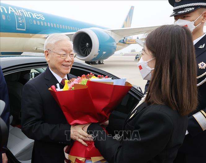 Nghi thức tặng hoa ch&agrave;o mừng tại lễ đ&oacute;n Tổng B&iacute; thư Nguyễn Ph&uacute; Trọng v&agrave; Đo&agrave;n đại biểu cấp cao Đảng Cộng sản Việt Nam ở S&acirc;n bay quốc tế Bắc Kinh. Ảnh: Tr&iacute; Dũng/TTXVN