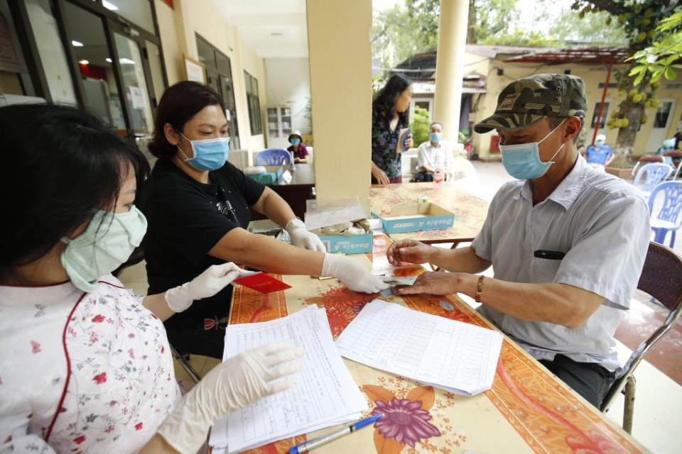 Chi trả tiền hỗ trợ vì gặp khó khăn do dịch Covid-19 tại UBND phường Láng Thượng, quận Đống Đa, TP Hà Nội. Ảnh: Gia Hân