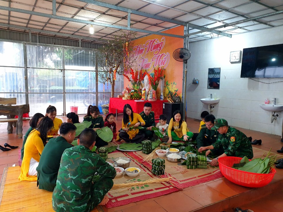 Giáo viên Trường Tiểu học Đào Phúc Lộc (TP Móng Cái, tỉnh Quảng Ninh) tham gia gói bánh chưng cùng các cán bộ, chiến sĩ tại Đồn Biên phòng Cửa khẩu quốc tế Móng Cái. Ảnh: Hồng Thái