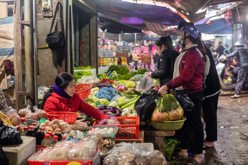 Cả khu chợ rộn r&atilde; tiếng mua h&agrave;ng, ch&agrave;o b&aacute;n, ngả gi&aacute;, tiếng hỏi thăm tr&ograve; chuyện của những người quen biết. Tất cả thanh &acirc;m ấy h&ograve;a v&agrave;o nhau tạo n&ecirc;n kh&ocirc;ng kh&iacute; nhộn nhịp, vui tươi khiến l&ograve;ng người n&ocirc; nức, phấn khởi ch&agrave;o một m&ugrave;a Xu&acirc;n mới.