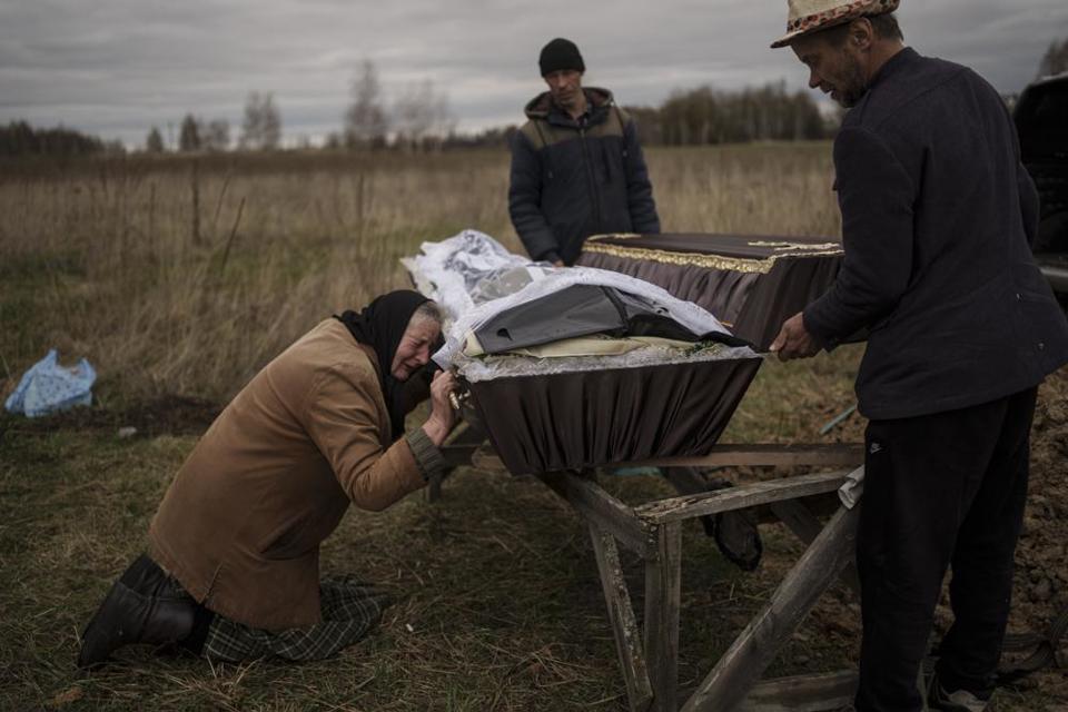 Nadiya Trubchaninova, 70 tuổi, vừa kh&oacute;c vừa quỳ b&ecirc;n quan t&agrave;i chứa h&agrave;i cốt của người con trai 48 tuổi của b&agrave; trong tang lễ ở nghĩa trang Mykulychi, ngoại &ocirc; thủ đ&ocirc; Kiev, Ukraine, ng&agrave;y 16/4/2022.
