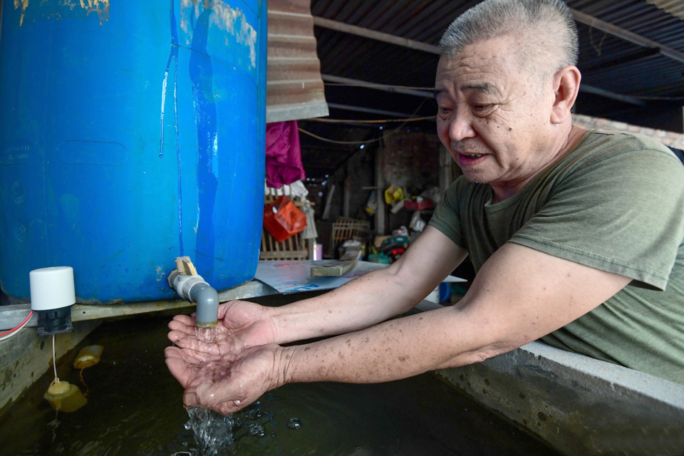 Người d&acirc;n x&atilde; Đức Thượng, huyện Ho&agrave;i Đức phải d&ugrave;ng nước giếng khoan để sinh hoạt khi bị cắt nước trong thời gian qua. Ảnh: Nguyễn Anh