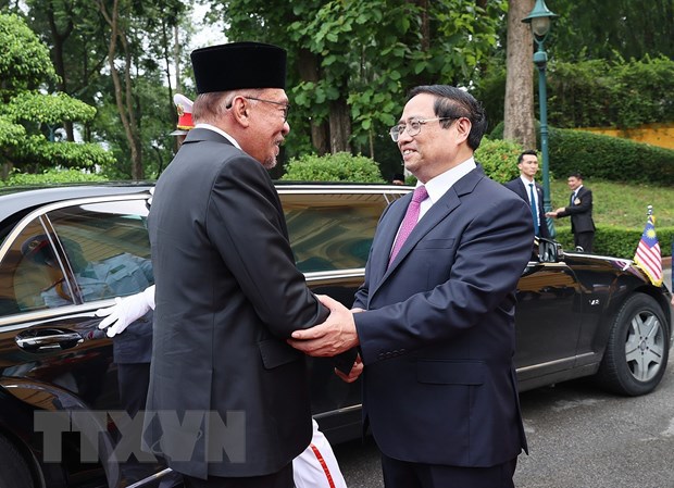 Thủ tướng Phạm Minh Ch&iacute;nh đ&oacute;n Thủ tướng Malaysia Anwar Ibrahim. (Ảnh: Dương Giang/TTXVN)