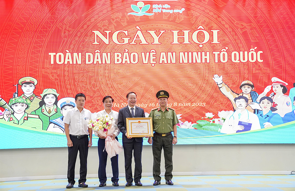 Đại t&aacute; Nguyễn Thanh B&igrave;nh - Ph&oacute; Cục trưởng Cục Phong tr&agrave;o BVANTQ tặng Bằng khen v&agrave; hoa ch&uacute;c mừng cho Bệnh viện Nhi Trung ương.