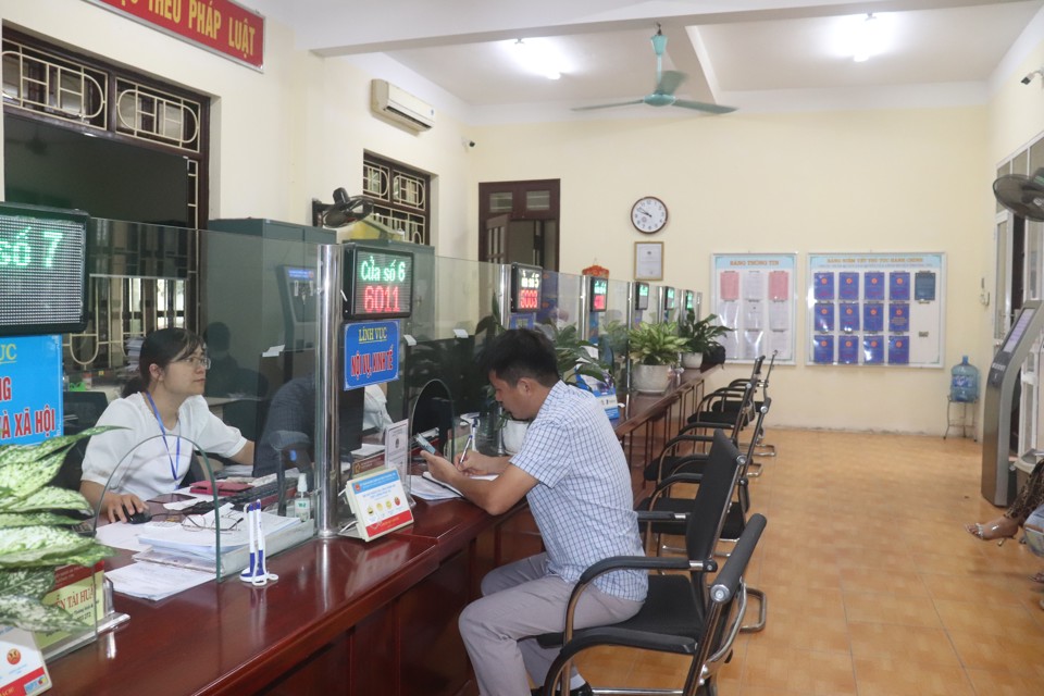 Công chức UBND huyện Thường Tín tiếp nhận giải quyết hồ sơ hành chính cho người dân. Ảnh: Thùy Linh