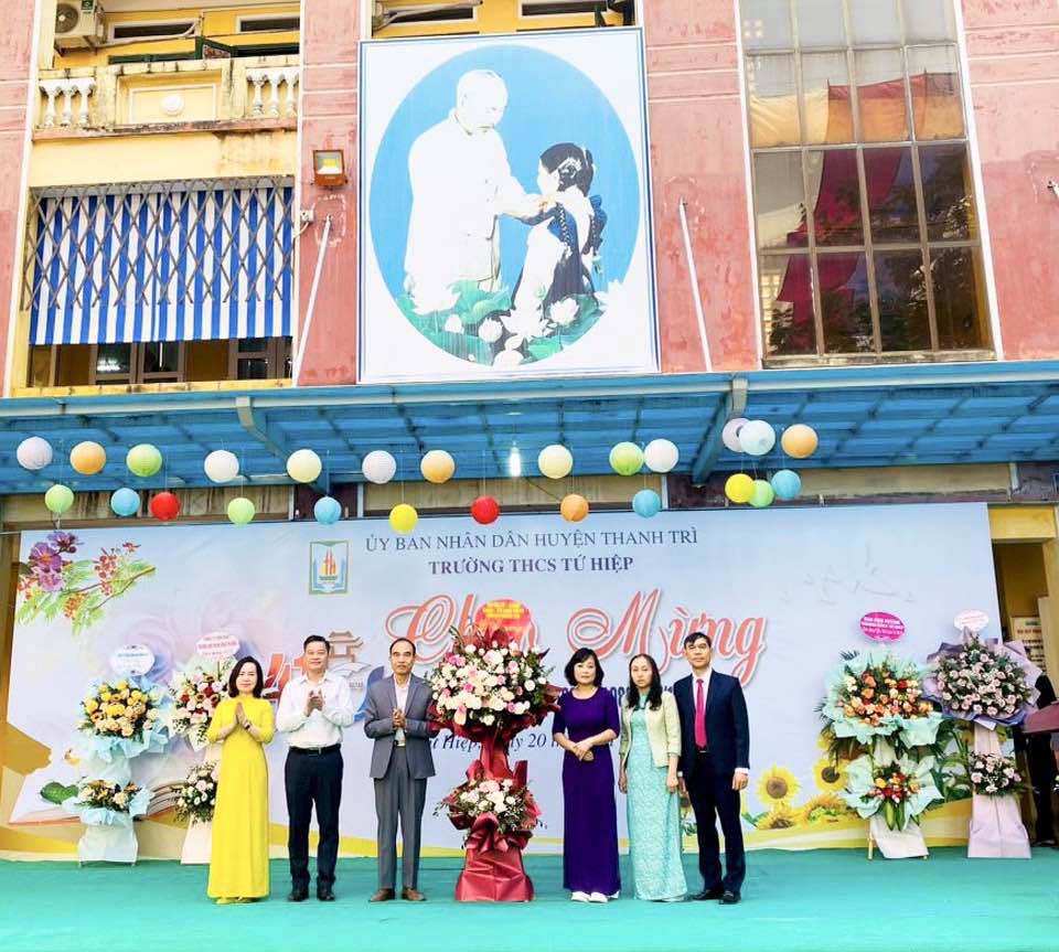 Chủ tịch Uỷ ban MTTQ huyện Thanh Tr&igrave; Nguyễn Huy Chương tặng hoa ch&uacute;c mừng tại Trường THCS Tứ Hiệp