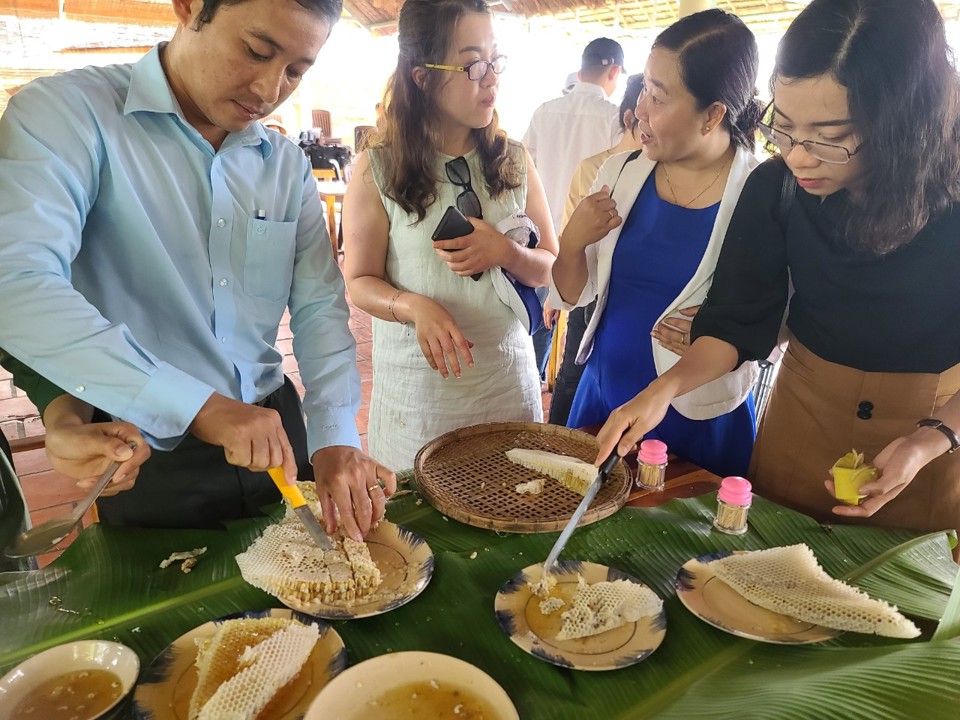 Du kh&aacute;ch đang thưởng thức m&oacute;n ong mật tại khu Du lịch Hương Tr&agrave;m huyện U Minh C&agrave; Mau (ảnh Ho&agrave;ng Nam)