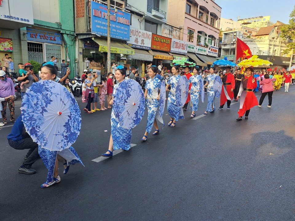 Đội thiếu nữ m&uacute;a d&ugrave; trong đo&agrave;n diễu h&agrave;nh. Ảnh: T&acirc;n Tiến.