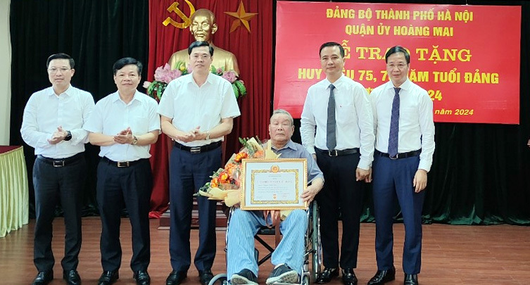 Ban Thường vụ Quận ủy Ho&agrave;ng Mai trao tặng Huy hiệu 75 năm tuổi Đảng cho đảng vi&ecirc;n Nguyễn Đ&igrave;nh Lộc. Ảnh TA