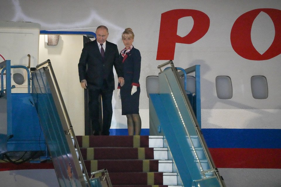 Tổng thống Vladimir Putin trong trang phục vest đen, bước ra cửa máy bay. Ảnh: Khánh Huy