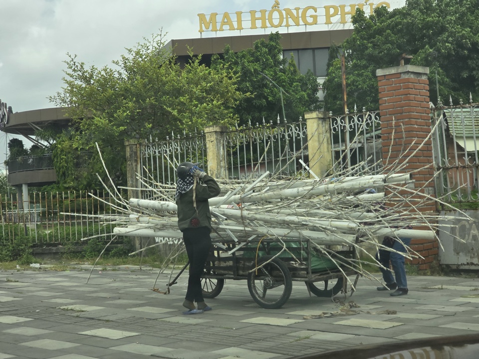 Nh&acirc;n vi&ecirc;n của trung t&acirc;m tiệc cưới Giang Thanh đang dỡ bỏ đ&egrave;n ch&ugrave;m trang tr&iacute; lấn chiếm vỉa h&egrave;. Ảnh Vĩnh Qu&acirc;n.