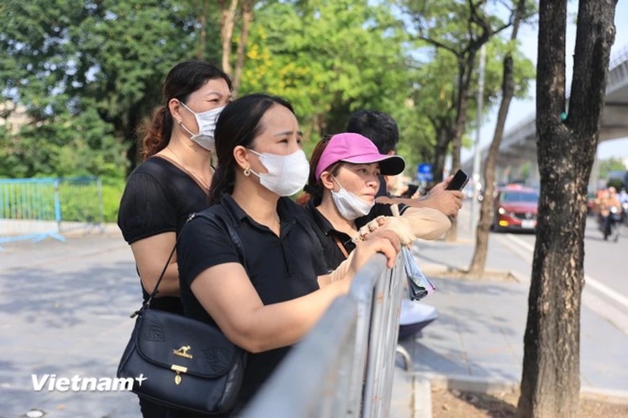 C&agrave;ng về trưa trời c&agrave;ng nắng n&oacute;ng, nhưng đo&agrave;n người vẫn trật tự, trang nghi&ecirc;m xếp h&agrave;ng trong khu vực r&agrave;o chắn. Ảnh: TTXVN