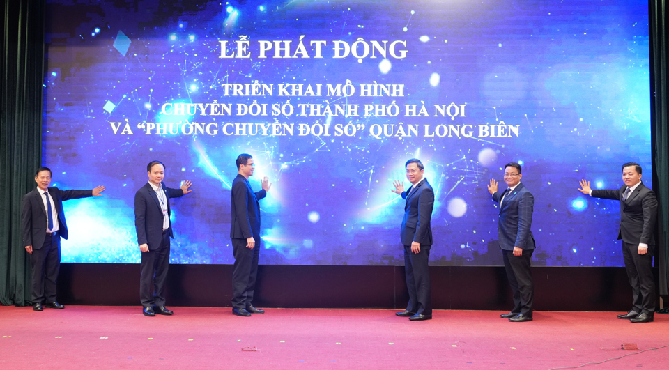 Ph&oacute; Chủ tịch UBND TP H&agrave; Minh Hải (thứ 3 từ phải qua) v&agrave; B&iacute; thư Quận ủy Long Bi&ecirc;n Đường Ho&agrave;i Nam (thứ 2 từ tr&aacute;i qua) c&ugrave;ng c&aacute;c đại biểu thực hiện nghi thức khai trương m&ocirc; h&igrave;nh chuyển đổi số TP H&agrave; Nội v&agrave; ''Phường chuyển đổi số'' tại quận Long Bi&ecirc;n. Ảnh: Nguyễn Trọng