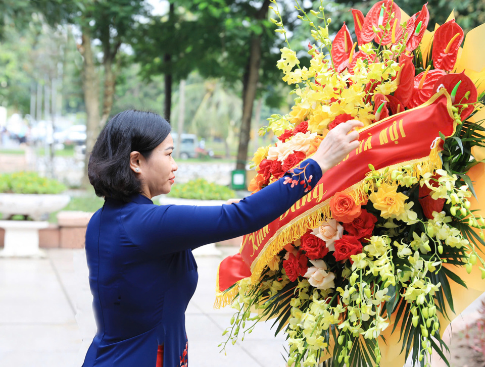 Ph&oacute; B&iacute; thư Thường trực Th&agrave;nh ủy Nguyễn Thị Tuyến chỉnh hoa d&acirc;ng l&ecirc;n&nbsp;Chủ tịch Hồ Ch&iacute; Minh v&agrave; Chủ tịch T&ocirc;n Đức Thắng.