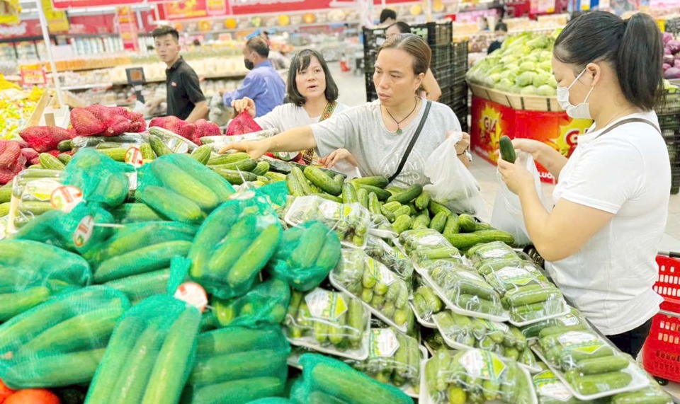 Người ti&ecirc;u d&ugrave;ng mua rau xanh tại si&ecirc;u thị Co.op Mart . Ảnh: Ho&agrave;i Nam