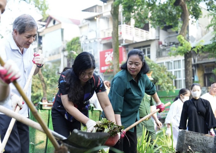 B&iacute; thư Th&agrave;nh ủy B&ugrave;i Thị Minh Ho&agrave;i tham gia dọn vệ sinh m&ocirc;i trường c&ugrave;ng người d&acirc;n tại Vườn hoa Vạn Xu&acirc;n