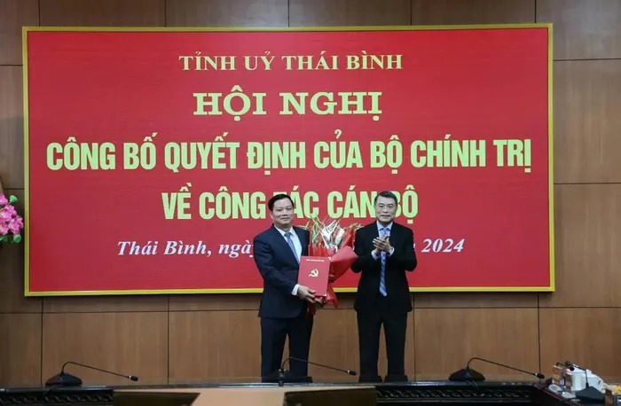 Bí thư Trung ương Đảng, Trưởng Ban Tổ chức Trung ương Lê Minh Hưng trao Quyết định, tặng hoa chúc mừng ông Nguyễn Khắc Thận, tân Bí thư Tỉnh ủy Thái Bình. Ảnh: TĐ