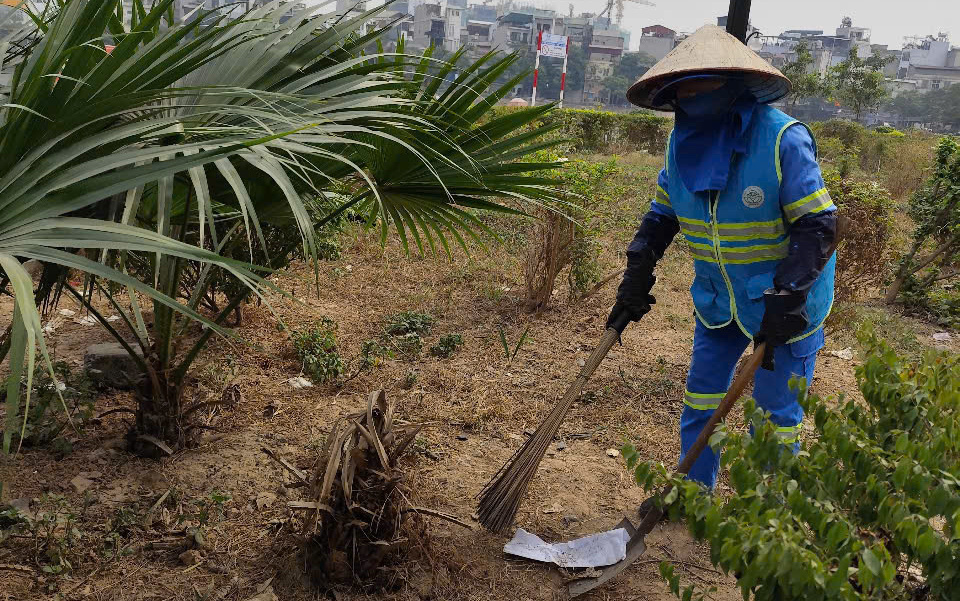 C&ocirc;ng nh&acirc;n vệ sinh m&ocirc;i trường dọn dẹp r&aacute;c thải xung quanh hồ Linh Quang.